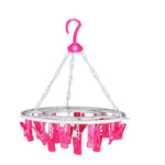 Sturdy multicolour round drying hanger with 24 clips, hanging various small items.