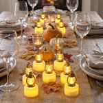 A festive table setting features numerous golden lantern LED candles, creating a warm ambiance amidst wine glasses and