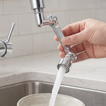 A hand adjusts a chrome swivel faucet aerator attached to a kitchen faucet, with water flowing into a bowl. – view 3