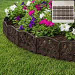 Plastic decorative garden fence border installed around flowers