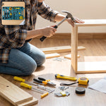 A person in a plaid shirt and jeans uses a hammer to assemble a light wood frame, surrounded by various tools.