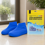 Two blue latex shoe covers next to a yellow and blue package for "Latex Waterproof Shoe Cover" on a tiled floor.