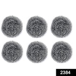 Heavy-duty stainless steel scrubber tackling tough grease on utensils.