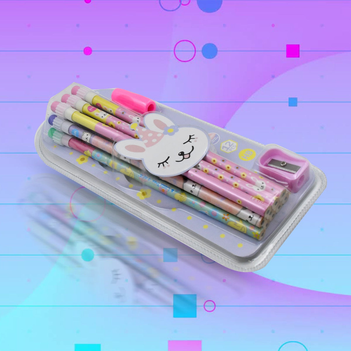 A clear pencil case with a bunny face contains twelve pastel pencils, a pink eraser, and a pink sharpener, set against a