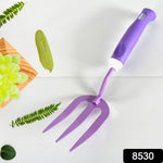 Sturdy metal cultivator from the garden tool kit for aerating soil.