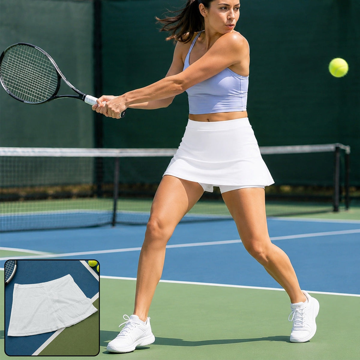 A woman in a white skort and lavender top plays tennis on a blue court, hitting a yellow ball.