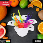 Six colorful dancing doll fruit forks in a white flower-shaped stand, surrounded by various fruits.
