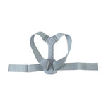 A grey posture corrector belt with a central grey spine support and adjustable straps, isolated on a white background.