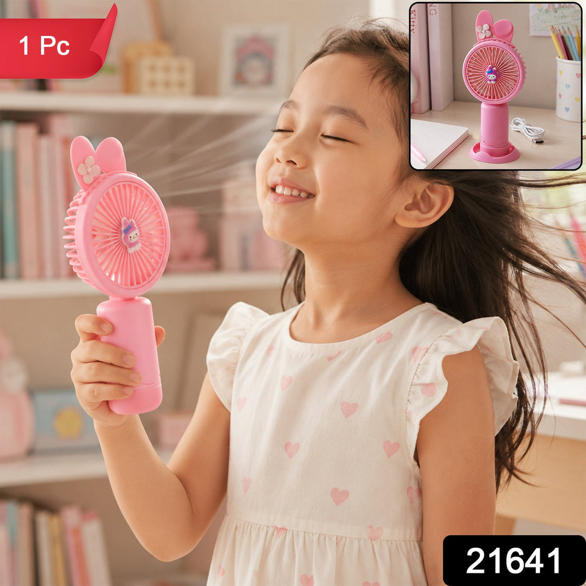 A close-up of the bottom of the pink bunny ear mini handheld fan, showing the charging port and a small white flower.