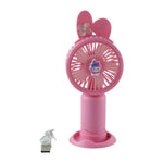 A pink bunny ear mini handheld fan with a small character on the grill, showing its dimensions of 18 cm height and 7 cm
