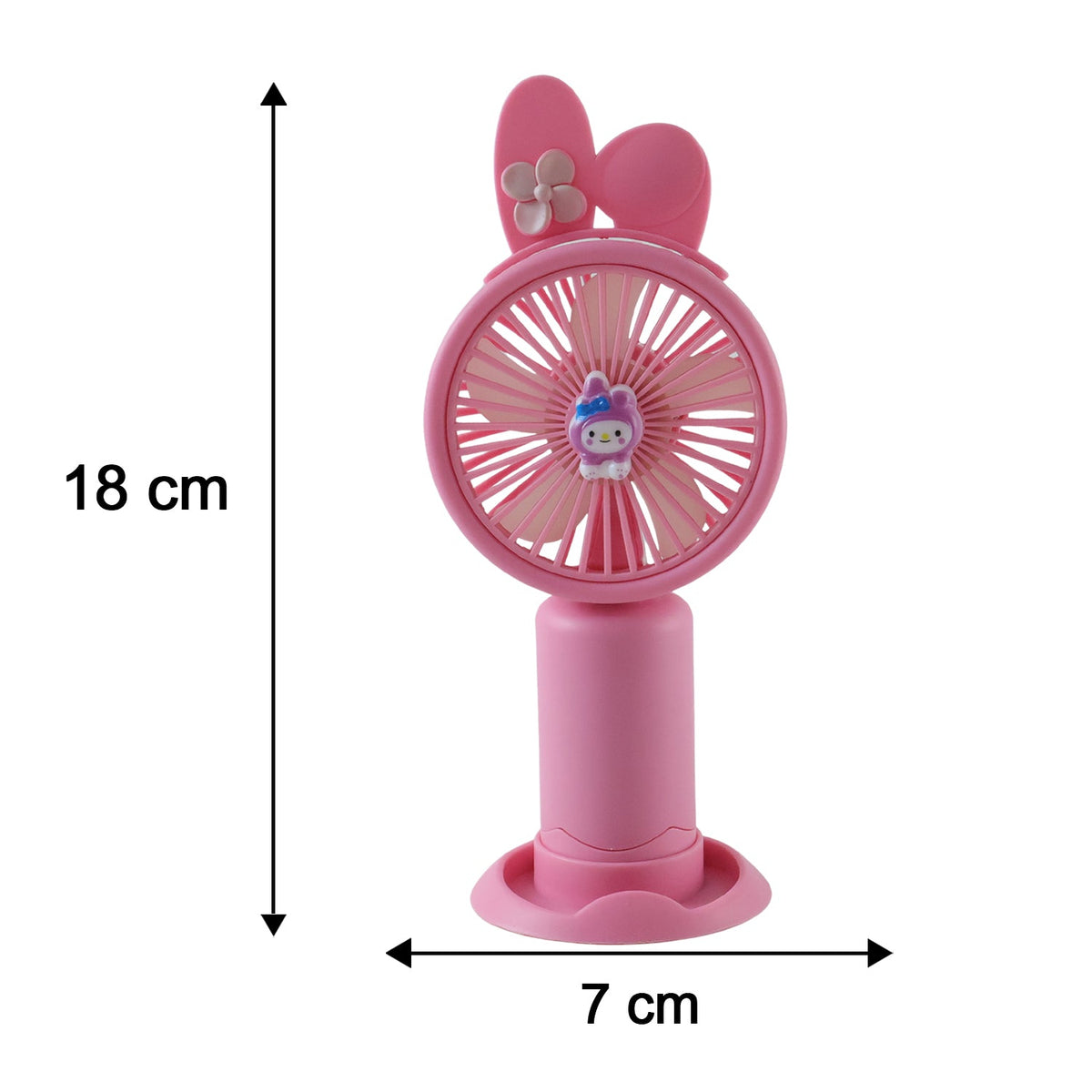 A pink bunny ear mini handheld fan with a small character on the grill sits on a wooden table in a garden with blooming