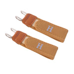 Two tan elastic belt hooks with brown faux leather accents and silver-colored metal hooks, against a white background.