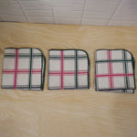 Actual photograph of three folded checked dish cloths
