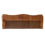 Wooden comb on white background highlighting natural wood finish