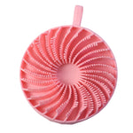 A pink silicone body scrubber with a spiral pattern of bristles and a hanging loop is shown on a white background.