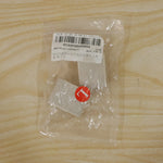 A clear plastic bag containing two beige elastic toe separators and a red circular sticker with the letter "L", lying on a
