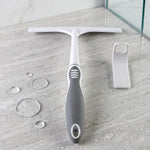 A white and gray glass wiper and a white hook on a marble surface with water droplets.