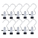 Ten shiny silver metal clip hangers with black rubber tips and S-shaped hooks are arranged in two rows on a white background.