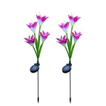 Two purple and white solar flower stake lights are displayed upright on a white background.
