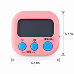 Hand holding digital kitchen timer showing its compact size