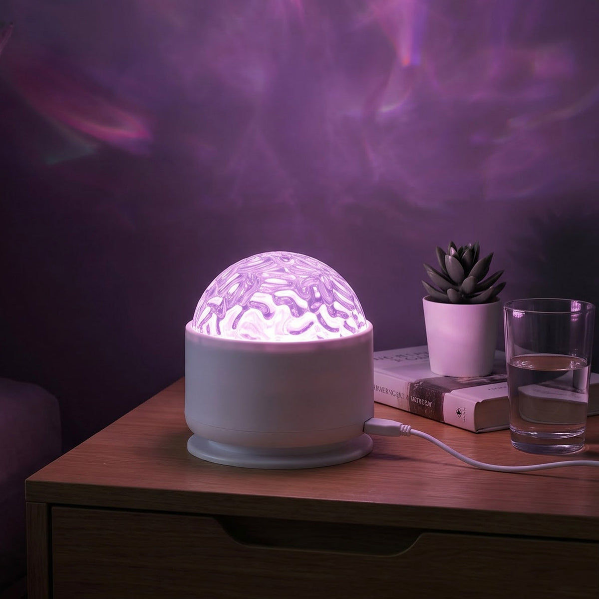 A white LED projection light on a bedside table, projecting purple wavy patterns onto the wall.