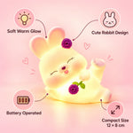 Detailed view of the reclining rabbit night light with floral accents