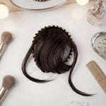 Woman styling her hair with synthetic clip-in bangs headband