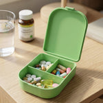 Pill organizer on bedside table for daily use.