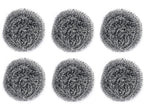 Close-up of a long-lasting round stainless steel scrubber in hand.