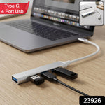 A silver Type C to four-port USB hub connected to a laptop, with a USB drive and cable plugged in.