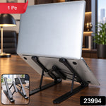 A silver laptop sits on a black adjustable stand, angled upwards on a wooden desk, with an inset showing the stand folded.