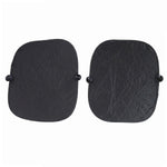 Two black foldable car sunshades with suction cups are laid flat against a plain white background.