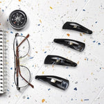 Matt black Metal Tic Tac Hair Clips on a neutral background, showcasing their sleek design.