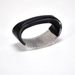 The ergonomic grip handles of the Quickslice garlic crusher, designed for comfortable use.