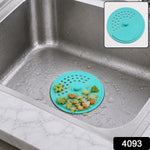 A teal silicone sink drain cover with food scraps in a stainless steel sink, with an inset showing the clean cover.