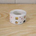 A single roll of white sealing tape with colorful cartoon characters on a light wooden surface.