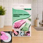 Product packaging for pink and green cleaning gloves with bristles, set on a kitchen counter.