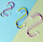 Six colorful plastic coated S hooks in yellow, blue, pink, and purple, arranged on a blue and green background.