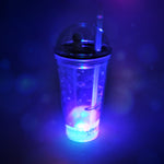Side view of the plastic astronaut tumbler with its LED base illuminated, perfect for kids.