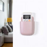 Four white wall mounted phone holders with charging ports displayed against a neutral background.