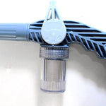The 8-in-1 water spray gun placed in a vibrant garden environment.