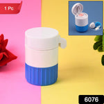 White and blue pill crusher and cutter on a pink and yellow background with a red flower.