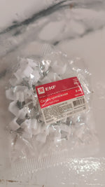 A clear plastic bag filled with white round nail clips, displaying a red and white product label.