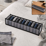 A gray 11-section fabric organizer filled with rolled socks sits on a white bedspread, with a smaller inset showing it on a