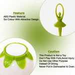 A close-up of a green dancing doll fruit fork and the base of the white flower-shaped stand with green accents.