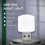 A white USB mini night light is displayed on a podium with text highlighting its soft lighting, portability, and USB plug.