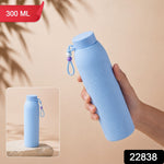 A hand holds a light blue ribbed glass water bottle with a beaded strap, with a smaller inset image showing it on a – view 2