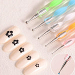 Textured grip on a nail art pen for better handling.