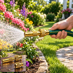 A person's hand holds a green hose with a brass nozzle spraying water into a vibrant garden. Inset shows two brass