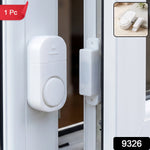 A white magnetic door and window security alarm is shown on a white window frame, with a small inset of the alarm on a